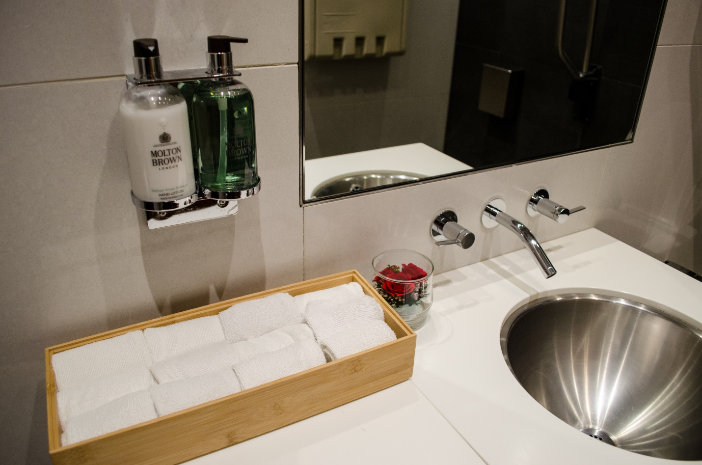 a bathroom sink with soap and soap dispenser