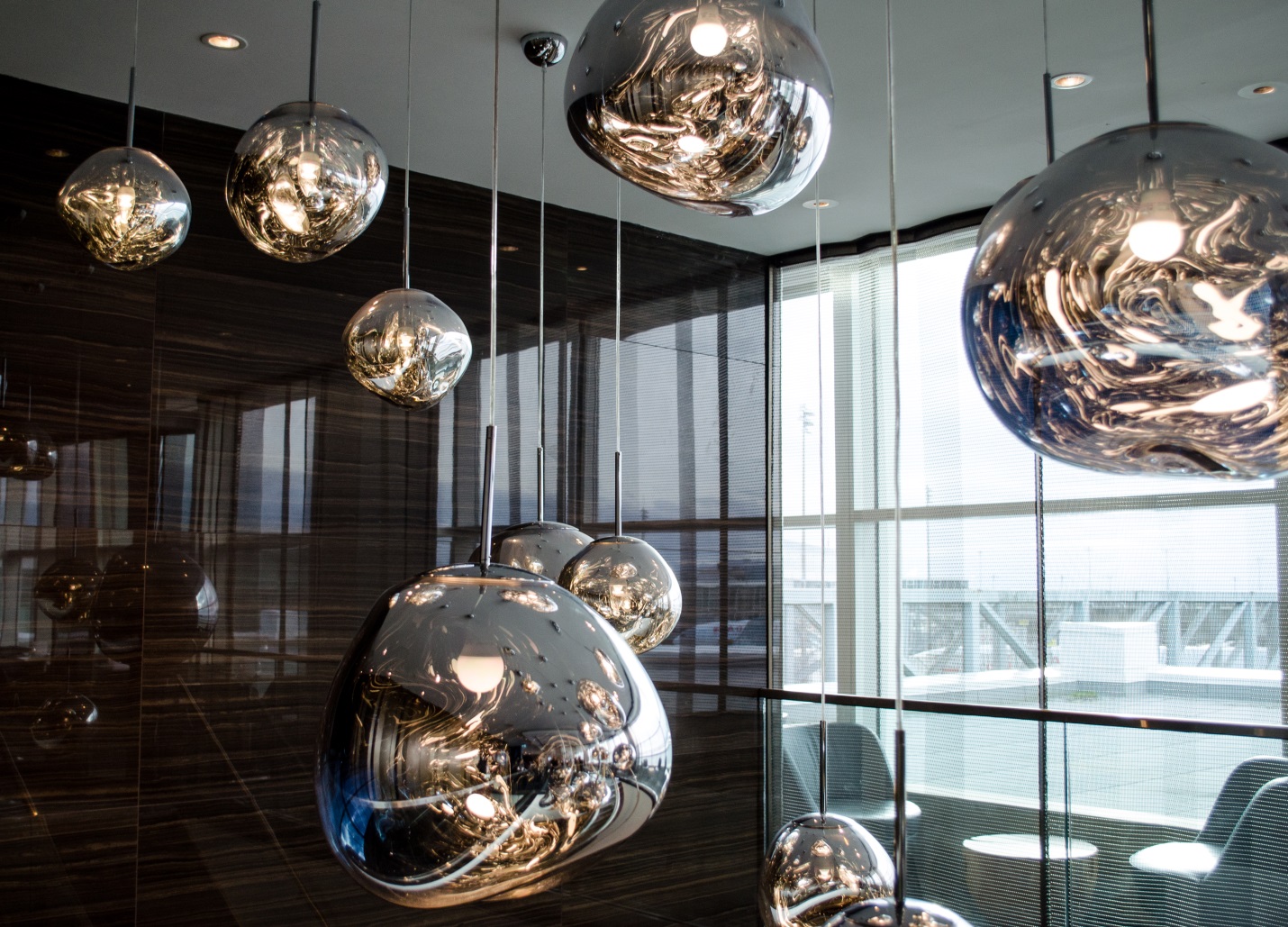 a group of shiny spheres from a ceiling